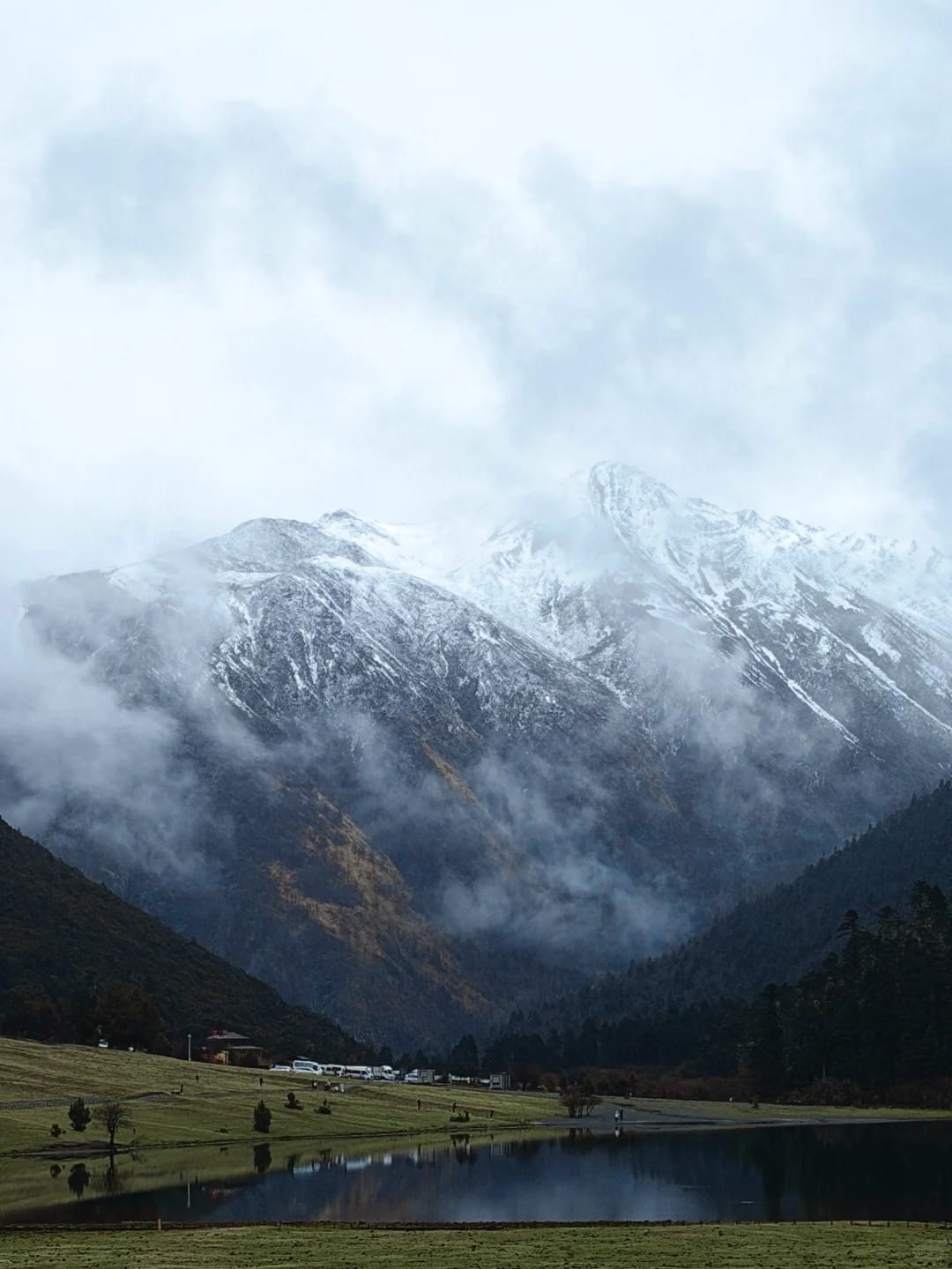 Rainy highland lake and snow mountains near Shangri-La for an 8-day Yunnan route